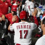 
              Cincinnati Reds' Kyle Farmer (17) celebrates with teammates after scoring on a Matt Reynolds single during the sixth inning of a baseball game against the Miami Marlins, Monday, July 25, 2022, in Cincinnati. (AP Photo/Jeff Dean)
            