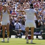 
              Tunisia's Ons Jabeur, right, gestures to Germany's Tatjana Maria to receive applause from the crowd after beating her in a women's singles semifinal match on day eleven of the Wimbledon tennis championships in London, Thursday, July 7, 2022. (AP Photo/Kirsty Wigglesworth)
            