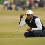 
              Tiger Woods of the US lines up a putt on the 11th green during the first round of the British Open golf championship on the Old Course at St. Andrews, Scotland, Thursday July 14, 2022. The Open Championship returns to the home of golf on July 14-17, 2022, to celebrate the 150th edition of the sport's oldest championship, which dates to 1860 and was first played at St. Andrews in 1873. (AP Photo/Gerald Herbert)
            