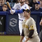 
              Los Angeles Dodgers' Cody Bellinger, left, hits a solo home run as San Diego Padres relief pitcher Craig Stammen watches during the sixth inning of a baseball game Friday, July 1, 2022, in Los Angeles. (AP Photo/Mark J. Terrill)
            