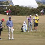 
              Kevin Kisner of the US, second right, prepares to play on the 17th hole as Trey Mullinax of the US, second left, watchesduring the third round of the British Open golf championship on the Old Course at St. Andrews, Scotland, Saturday July 16, 2022. (AP Photo/Peter Morrison)
            
