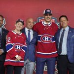 
              Juraj Slafkovsky, second from right, poses for photos with Montreal Canadiens owner Geoff Molson, left, after being selected as the top pick in the first round of the NHL draft by the Canadiens in Montreal, Thursday, July 7, 2022. (Ryan Remiorz/The Canadian Press via AP)
            