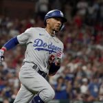 
              Los Angeles Dodgers' Mookie Betts round ds first on his way to an RBI double during the eighth inning of a baseball game against the St. Louis Cardinals Wednesday, July 13, 2022, in St. Louis. (AP Photo/Jeff Roberson)
            