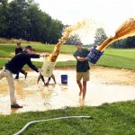 
              Grounds crew remove water from a bunker during a weather suspension in the third round in the Barbasol Championship golf tournament Saturday, July 9, 2022, in Nicholasville, Ky. (AP Photo/John Amis)
            