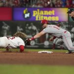 
              St. Louis Cardinals' Brendan Donovan, left, is tagged out at second by Cincinnati Reds shortstop Kyle Farmer during the sixth inning of a baseball game Friday, July 15, 2022, in St. Louis. (AP Photo/Jeff Roberson)
            