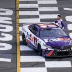 
              Denny Hamlin (11) gets out of his car after winning the NASCAR Cup Series auto race at Pocono Raceway, Sunday, July 24, 2022, in Long Pond, Pa. (AP Photo/Matt Slocum)
            