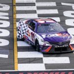 
              Taylor James Hamlin, left, waves the checker flag from inside the car with her dad, Denny Hamlin after he won the NASCAR Cup Series auto race at Pocono Raceway, Sunday, July 24, 2022, in Long Pond, Pa. (AP Photo/Matt Slocum)
            