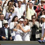 
              Kazakhstan's Elena Rybakina hugs members of her team after the final of the women's singles against Tunisia's Ons Jabeur on day thirteen of the Wimbledon tennis championships in London, Saturday, July 9, 2022. (AP Photo/Gerald Herbert)
            