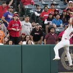 
              Fans watch as Los Angeles Angels' Brandon Marsh catches a ball hit by Houston Astros' Jose Altuve during the third inning of a baseball game Tuesday, July 12, 2022, in Anaheim, Calif. (AP Photo/Jae C. Hong)
            