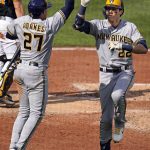 
              Milwaukee Brewers' Christian Yelich (22) celebrates with teammate Willy Adames after hitting a solo home run off Pittsburgh Pirates starting pitcher Bryse Wilson during the fifth inning of a baseball game in Pittsburgh, Saturday, July 2, 2022. (AP Photo/Gene J. Puskar)
            