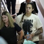 
              FILE - WNBA star and two-time Olympic gold medalist Brittney Griner is escorted to a courtroom for a hearing, in Khimki, just outside Moscow, Russia, July 1, 2022. Jailed American basketball star Brittney Griner returns to a Russian court Thursday July 7, 2022, as calls increase for Washington to do more to secure her release. Griner was detained in February at a Moscow airport after vape canisters with cannabis oil allegedly were found in her luggage. (AP Photo/Alexander Zemlianichenko, File)
            