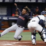 
              Cleveland Guardians' Jose Ramirez slides past Tampa Bay Rays catcher Rene Pinto to score during the fourth inning of a baseball game, Saturday, July 30, 2022, in St. Petersburg, Fla. (AP Photo/Scott Audette)
            