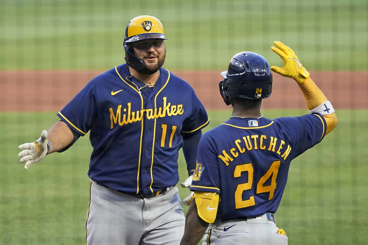 Milwaukee Brewers' Rowdy Tellez (11) celebrates with Andrew McCutchen after hitting a three-run hom...