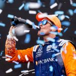 
              Scott Dixon, of New Zealand, celebrates with champagne in the Winners Circle after winning  an IndyCar auto race in Toronto, Sunday, July 17, 2022. (Mark Blinch/The Canadian Press via AP)
            