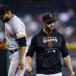 
              San Francisco Giants manager Gabe Kapler, right, heads back to the dugout after talking with relief pitcher Jarlin Garcia, left, during the fifth inning of a baseball game against the Arizona Diamondbacks, Monday, July 25, 2022, in Phoenix. (AP Photo/Ross D. Franklin)
            
