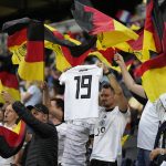 
              A Germany supporter holds a jersey of Germany's Klara Buehl during the Women Euro 2022 semifinal soccer match between Germany and France at Stadium MK in Milton Keynes, England, Wednesday, July 27, 2022. Buehl is unable to play due to having been infected with COVID-19. (AP Photo/Alessandra Tarantino)
            
