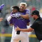 
              Colorado Rockies' Elias Diaz, center front, is congratulated after he drove in the tying and winning runs against the Chicago White Sox in the ninth inning of a baseball game Wednesday, July 27, 2022, in Denver. From left are Brendan Rodgers, Yonathan Daza and Kyle Freeland. (AP Photo/David Zalubowski)
            