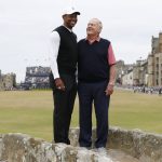 
              Tiger Woods, left, and Jack Nicklaus, both from the United States pose for a photo on the Swilken Bridge during a 'Champions round' as preparations continue for the British Open golf championship on the Old Course at St. Andrews, Scotland, Monday July 11, 2022. The Open Championship returns to the home of golf on July 14-17, 2022, to celebrate the 150th edition of the sport's oldest championship, which dates to 1860 and was first played at St. Andrews in 1873. (AP Photo/Peter Morrison)
            