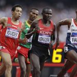 
              FILE - Britain's Mo Farah, right, leads the pack in the men's 5000-meter final during the athletics in the Olympic Stadium at the 2012 Summer Olympics, London, Saturday, Aug. 11, 2012. Four-time Olympic champion Mo Farah has disclosed he was brought into Britain illegally from Djibouti under the name of another child. The British athlete made the revelation in a BBC documentary. (AP Photo/Hassan Ammar, File)
            