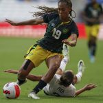 
              Jamaica's Tiernny Wiltshire (19) controls the ball as United States' Mallory Pugh falls on the pitch during a CONCACAF Women's Championship soccer match in Monterrey, Mexico, Thursday, July 7, 2022. (AP Photo/Fernando Llano)
            