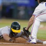 
              Oakland Athletics' Seth Brown is tagged out attempting to steal third by Texas Rangers third baseman Josh Smith during the eighth inning of a baseball game Tuesday, July 12, 2022, in Arlington, Texas. (AP Photo/Tony Gutierrez)
            