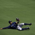 
              Seattle Mariners center fielder Julio Rodriguez slides after making a catch for the out on San Diego Padres' Luke Voit during the seventh inning of a baseball game Tuesday, July 5, 2022, in San Diego. (AP Photo/Gregory Bull)
            