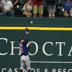 
              Minnesota Twins left fielder Gilberto Celestino leaps to make a catch on a fly out by Texas Rangers' Nathaniel Lowe in the eighth inning of a baseball game, Sunday, July 10, 2022, in Arlington, Texas. (AP Photo/Tony Gutierrez)
            