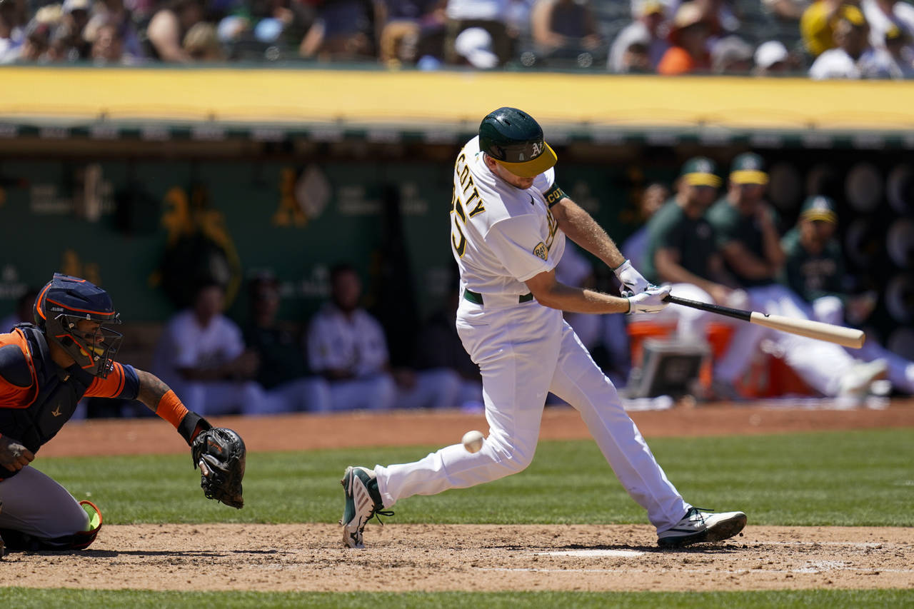 Oakland Athletics' Stephen Piscotty, right, strikes out against the Houston Astros to end the sixth...