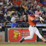 
              Houston Astros' Alex Bregman hits an RBI single in front of Seattle Mariners catcher Cal Raleigh during the fourth inning of a baseball game Friday, July 29, 2022, in Houston. (AP Photo/Michael Wyke)
            