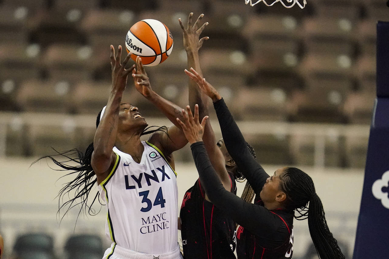 Minnesota Lynx center Sylvia Fowles (34) goes up for a rebound with Indiana Fever center Queen Egbo...