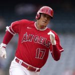 
              Los Angeles Angels' Shohei Ohtani runs to third after hitting a triple during the first inning of a baseball game against the Texas Rangers Sunday, July 31, 2022, in Anaheim, Calif. (AP Photo/Mark J. Terrill)
            