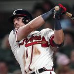 
              Atlanta Braves' Austin Riley follows through on a home run in the seventh inning of a baseball game against the New York Mets, Monday, July 11, 2022, in Atlanta. (AP Photo/John Bazemore)
            