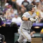 
              Pittsburgh Pirates' Yoshi Tsutsugo, right, follows the flight of his fly out with Colorado Rockies catcher Brian Serven during the ninth inning of a baseball game Saturday, July 16, 2022, in Denver. (AP Photo/David Zalubowski)
            