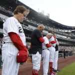
              Chicago White Sox manager Tony La Russa left, and his coaches bow their heads during a moment of silence at Guaranteed Rate Field for the victims of a Fourth of July parade shooting in nearby Highland Park, Ill., Monday, July 4, 2022, in Chicago before a baseball game between the Chicago White Sox and the Minnesota Twins. (AP Photo/Paul Beaty)
            