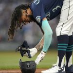 
              Seattle Mariners' J.P. Crawford places his batting pads into his helmet after he flew out with a runner on base to end the fifth inning of the team's baseball game against the Houston Astros, Friday, July 22, 2022, in Seattle. (AP Photo/Ted S. Warren)
            