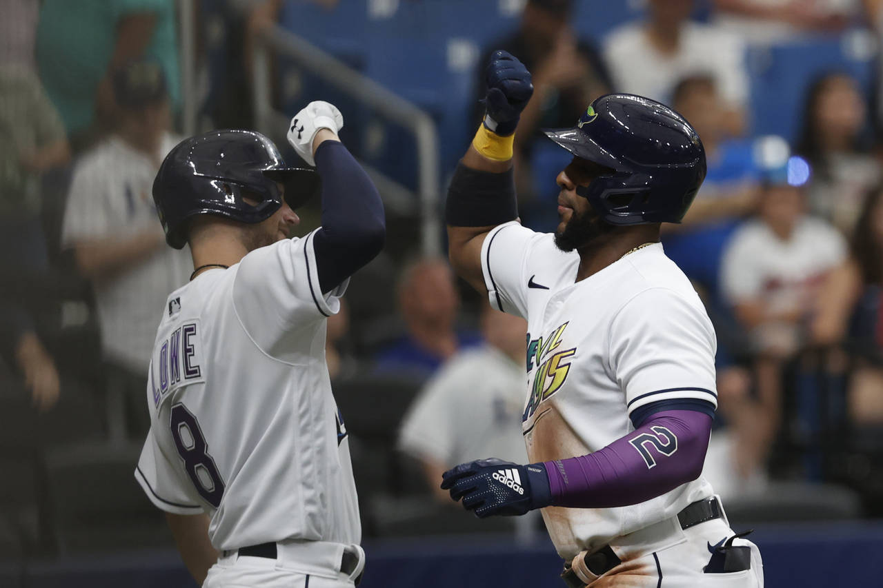 Tampa Bay Rays' Yandy Diaz, right, celebrates with teammate Brandon Lowe after hitting a home run a...
