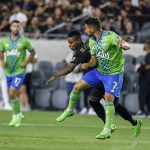 
              Seattle Sounders midfielder Cristian Roldan, right, and Los Angeles FC midfielder Latif Blessing vie for the ball during the first half of an MLS soccer match Friday, July 29, 2022, in Los Angeles. (AP Photo/Ringo H.W. Chiu)
            