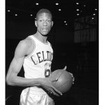 
              FILE - Bill Russell, of San Francisco, wears a Boston Celtics uniform for his first workout with the NBA team shortly after having signed a contract in Boston on Dec. 19, 1956.  The NBA great Bill Russell has died at age 88. His family said on social media that Russell died on Sunday, July 31, 2022. Russell anchored a Boston Celtics dynasty that won 11 titles in 13 years. (AP Photo)
            