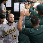 
              Oakland Athletics' Seth Brown (15) celebrates his home run in the dugout during the third inning of a baseball game against the Chicago White Sox Saturday, July 30, 2022, in Chicago. (AP Photo/Charles Rex Arbogast)
            