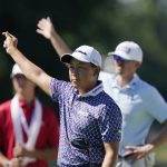 
              Dylan Wu signals after driving off the 18th tee during the second round of the Rocket Mortgage Classic golf tournament, Friday, July 29, 2022, in Detroit. (AP Photo/Carlos Osorio)
            