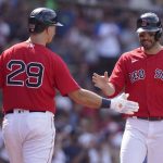
              Boston Red Sox's Bobby Dalbec (29) welcomes J.D. Martinez to the dugout after Martinez scored on a double by Christian Vazquez in the fifth inning of a baseball game against the Milwaukee Brewers, Sunday, July 31, 2022, in Boston. (AP Photo/Steven Senne)
            