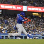 
              Chicago Cubs' Christopher Morel, right, hits a two-run home run as Los Angeles Dodgers catcher Will Smith watches during the fifth inning of a baseball game Thursday, July 7, 2022, in Los Angeles. (AP Photo/Mark J. Terrill)
            