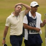 
              Rory McIlroy of Northern Ireland walk from the 18th green with his caddie after finishing his final round of the British Open golf championship on the Old Course at St. Andrews, Scotland, Sunday July 17, 2022. (AP Photo/Gerald Herbert)
            