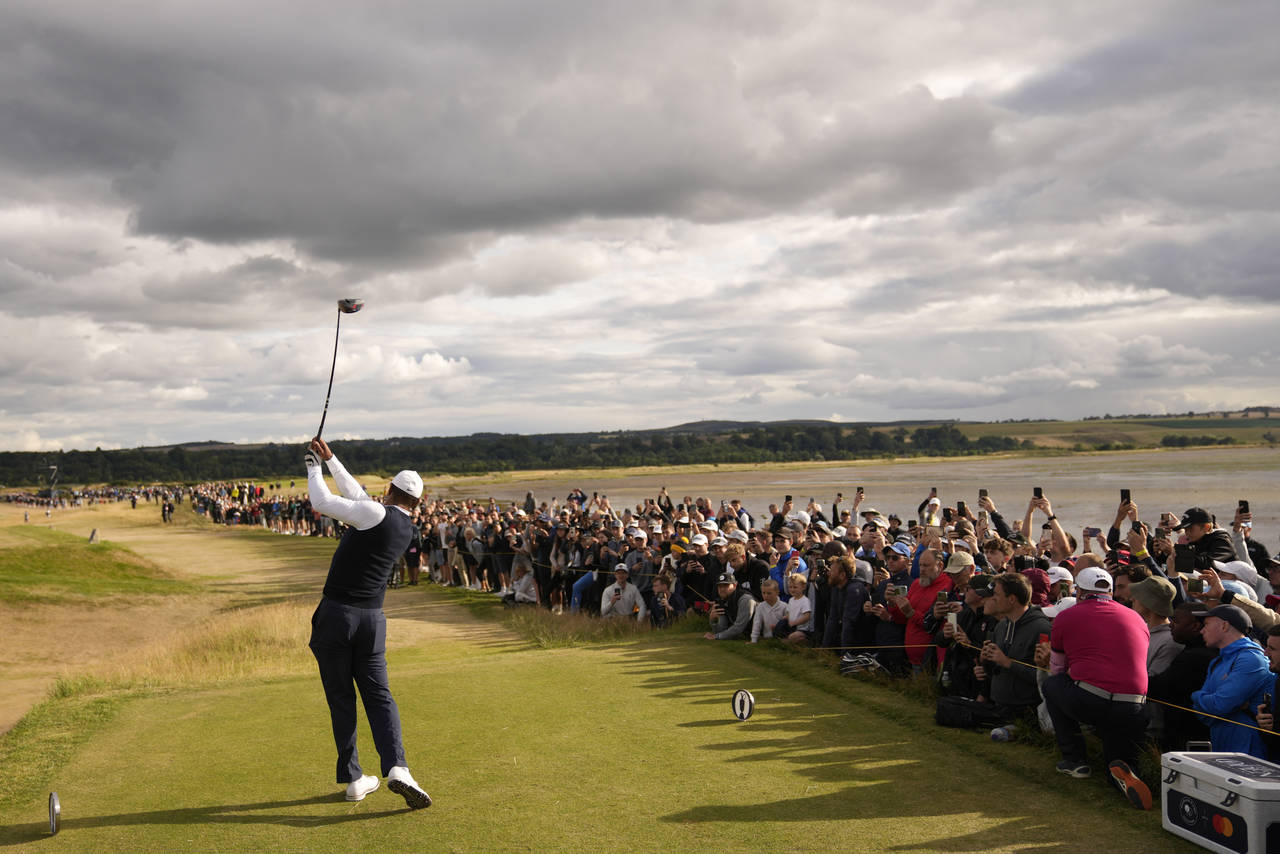 Tiger Woods of the US plays from the 12th tee during the first round of the British Open golf champ...