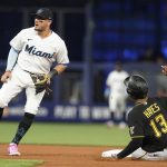 
              Pittsburgh Pirates' Ke'Bryan Hayes (13) steals second base as Miami Marlins shortstop Miguel Rojas (11) is late with the tag during the first inning of a baseball game, Monday, July 11, 2022, in Miami. (AP Photo/Marta Lavandier)
            