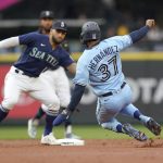 
              Toronto Blue Jays' Teoscar Hernandez (37) slides, but is tagged out at second base by Seattle Mariners second baseman Abraham Toro, left, on an attempted steal during the second inning of a baseball game Saturday, July 9, 2022, in Seattle. (AP Photo/Ted S. Warren)
            