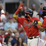 
              Atlanta Braves' Ronald Acuna Jr., center, celebrates with Michael Harris II, left, and Orlando Arcia (11) after hitting a three-run home run off Washington Nationals' Erick Fedde during the second inning of a baseball game Friday, July 8, 2022, in Atlanta. (AP Photo/Ben Margot)
            
