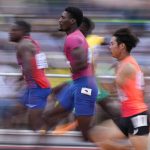 
              Fred Kerley, of the United States, (pink shirt) wins a semifinal in the men's 100-meter run at the World Athletics Championships on Saturday, July 16, 2022, in Eugene, Ore. (AP Photo/Charlie Riedel)
            
