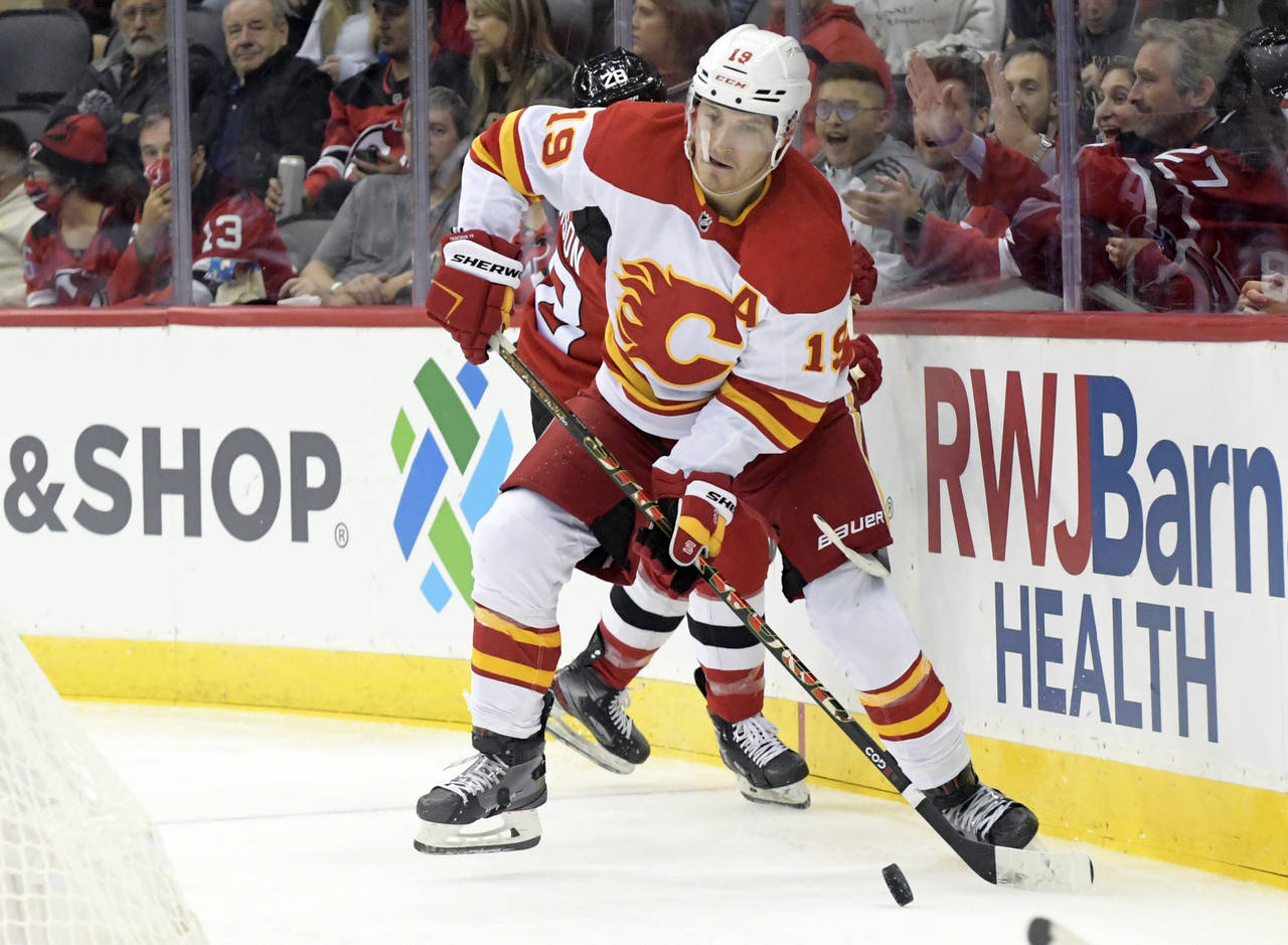 FILE - Calgary Flames left wing Matthew Tkachuk (19) looks to pass the puck during the second perio...
