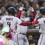 
              Arizona Diamondbacks' Christian Walker, center, celebrates with Ketel Marte (4) and David Peralta (6) after hitting a two-run home run against the San Diego Padres during the fourth inning of a baseball game Friday, July 15, 2022, in San Diego. (AP Photo/Derrick Tuskan)
            